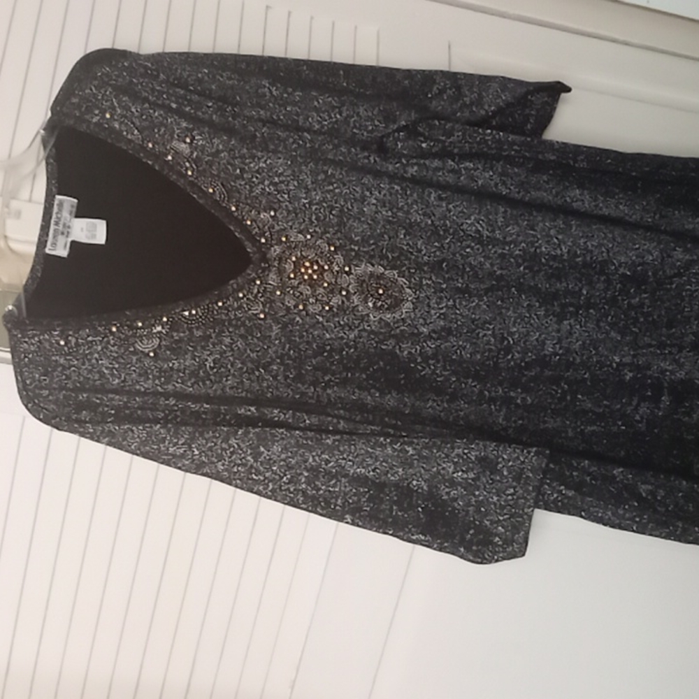 A longer sleeve fancy tunic with decorative trim.